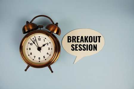 Breakout session text on speech bluble with alarm clock top view on blue background