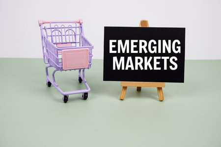 Emerging Markets text message and trolley shopping cart on green backgroundの写真素材