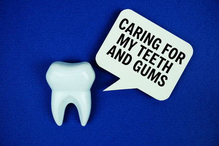 Caring For My Teeth And Gums text on speech bubble with white tooth model on blue backgroundの写真素材