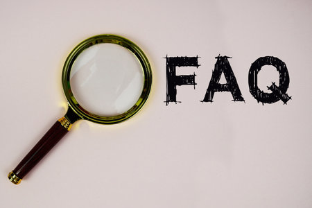 FAQ text with magnifying glass on pink backgroundの写真素材