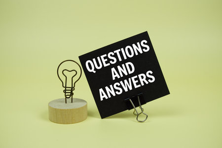 Questions and Answers text message on sticky note with on yellow backgroundの写真素材