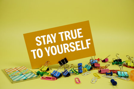Stay True To Yourself text on paper card with stationery on yellow backgroundの写真素材