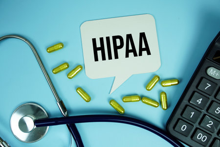 HIPAA, Health Insurance Portability and Accountability text with calculator, stethoscope and capsule medicine on blue background, Healthy and wellness conceptの写真素材