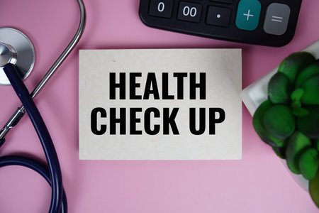Health Check up text with stethoscope on pink background, Healthy and wellness conceptの写真素材