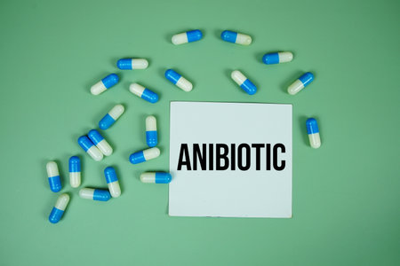 Anibiotic text with Medicine Capsule on green backgroundの写真素材