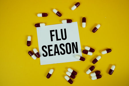 Flu Season text on sticky paper note with Medicine Capsule on yellow backgroundの写真素材