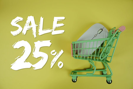 Sale 25% Special Discount shopping online with trolley shopping cart and optical mouse on yellow...
