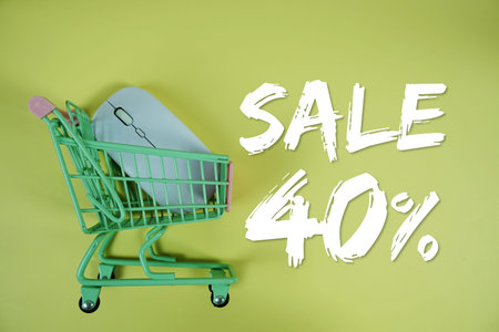 Sale 40% Special Discount shopping online with trolley shopping cart and optical mouse on yellow...