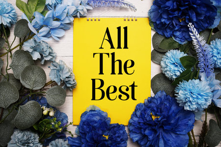 All The Best text with blue flowers bouquet decoration on wooden background