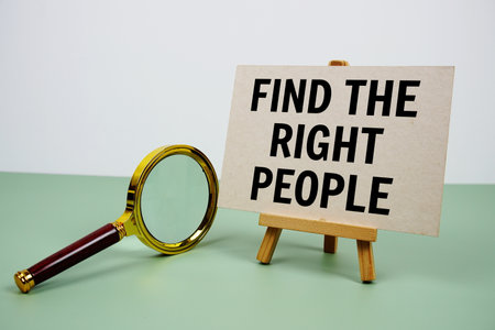 Find the right people text on paper card with magnifying glass on green backgroundの写真素材