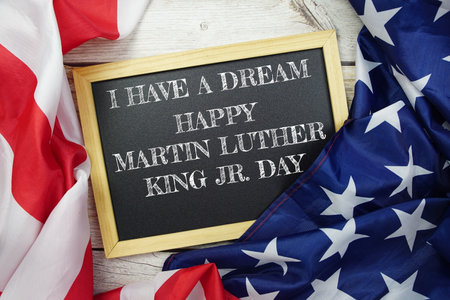 Happy Martin Luther King Jr Day text messege with USA flag on wooden background, America national holiday conceptの写真素材