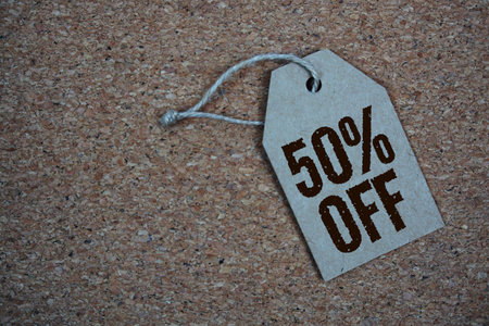 Sale 50% Off text on price tag top view on cork paper backgroundの写真素材