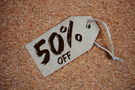 Sale 50% off with price tag on cork board backgroundの写真素材