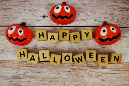 Happy Halloween text with element decorations on wooden backgroundの写真素材
