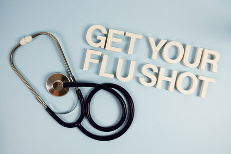 Get Your Flu Shot alphabet letters with stethoscope top view on blue background
