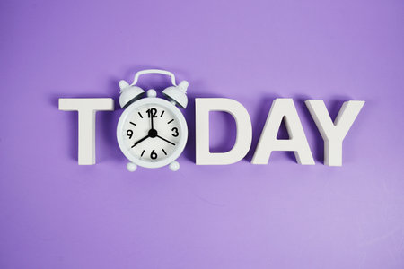 Today alphabet letters with alarm clock on purple backgroundの写真素材