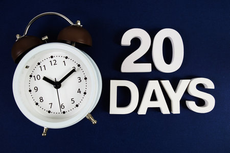 20 Days alphabet letters with alarm clock on navy blue backgroundの写真素材