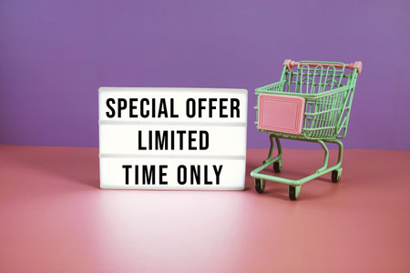 Special Offer Limited Time Only text on LED lightbox with trolley shopping cart on pink and purple...