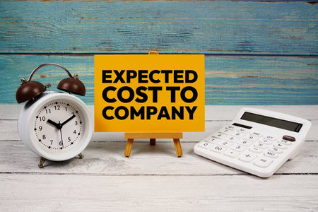 Expected Cost To Company text written on paper card with calculator and alarm clock on wooden backgroundの写真素材