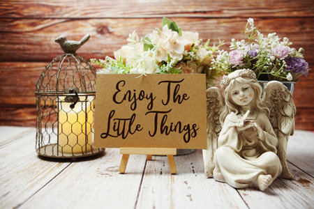 Enjoy The Little Things text on paper card with easel and elements decorated