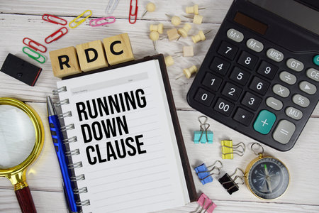 RDC - Running Down Clause acronym on notepad, Business and Financial concept background
