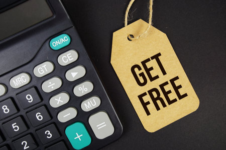 Get Free text on price tag with calculator on black backgroundの写真素材
