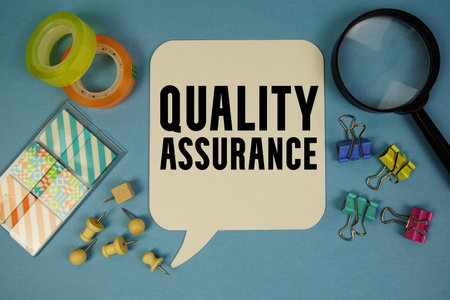 Quality Assurance text with magnifying glass on blue backgroundの写真素材