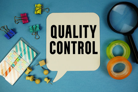 Quality Control text with magnifying glass on blue backgroundの写真素材