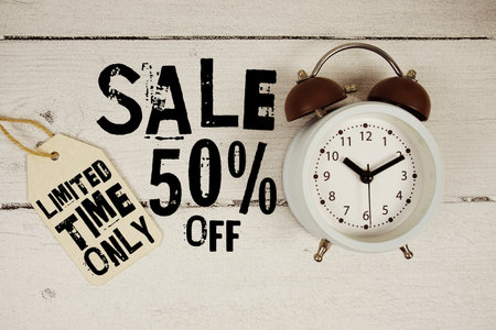 Sale 50% off Limited Time Only text with alarm clock on wooden backgroundの写真素材