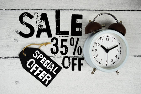 Sale 35% off Special Offer text with alarm clock on wooden backgroundの写真素材
