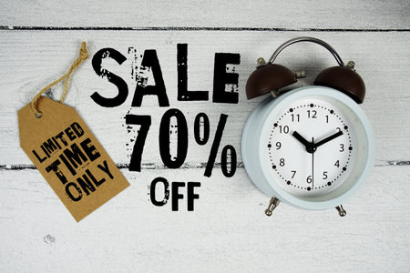 Sale 70% Limited Time Offer text with alarm clock on wooden backgroundの写真素材