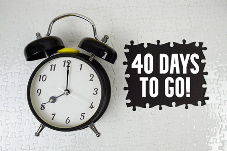 40 Days To Go! text with alarm clock on black backgroundの写真素材