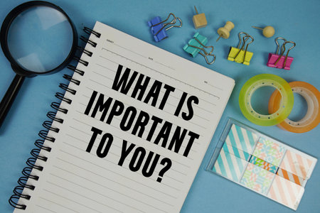What is important to you? text with magnifying glass on blue backgroundの写真素材