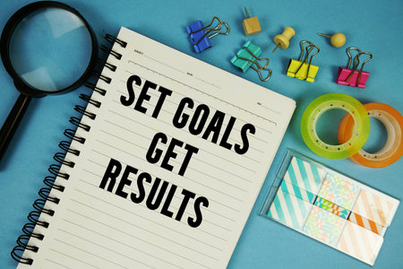 Set Goals Get Results text with magnifying glass on blue backgroundの写真素材