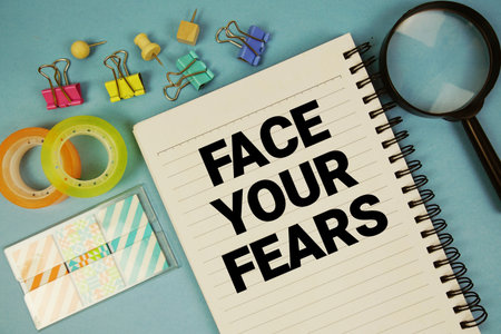 Face Your Fears text with magnifying glass on blue backgroundの写真素材