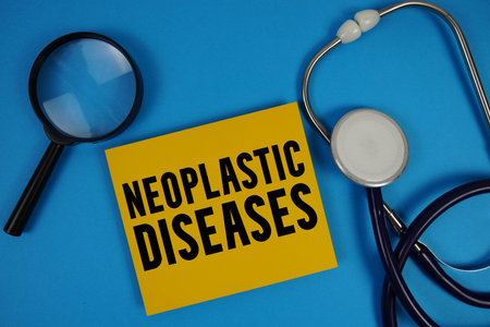 Neoplastic Diseases  text with Stethoscope and magnifying glass on blue background