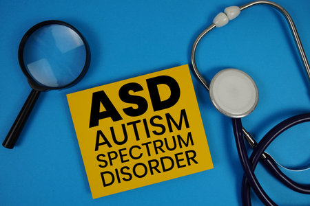 Autism Spectrum Disorder (ASD)  text with Stethoscope and magnifying glass on blue backgroundの写真素材
