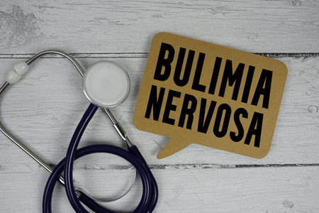 Bulimia Nervosa text with Stethoscope on wooden background