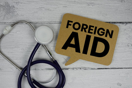 Foreign Aid text with Stethoscope on wooden backgroundの写真素材