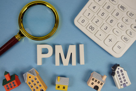 PMI abbreviation of Private Mortgage Insurance alphabet letters with house model, magnifying glass and calculator on blue backgroundの写真素材