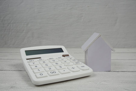 House Model and Caculator on wooden backgroundの写真素材