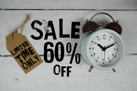 Sale 60% of Limited Time Only text with alarm clock on wooden backgroundの写真素材