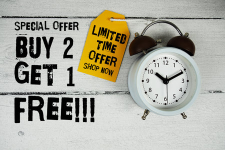Buy 1 Get 1 Free!!! Special Offer text with alarm clock on wooden backgroundの写真素材
