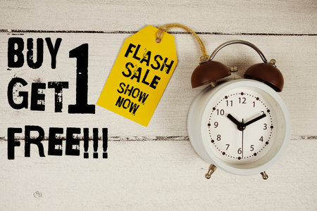 Buy 1 Get 1 Free!!! Shop Now text with alarm clock on wooden backgroundの写真素材