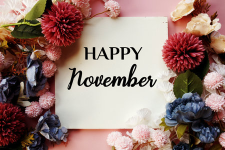 Happy November text with flowers decorations on pink backgroundの写真素材