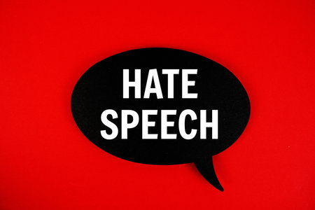 Hate Speech text with speech bubble on red background