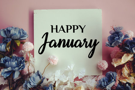 Happy January text with flowers decorations on pink backgroundの写真素材