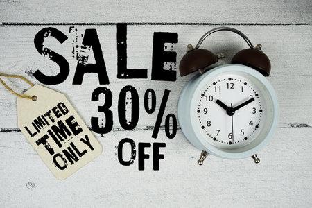 Sale 30% of Limited Time Only text with alarm clock on wooden backgroundの写真素材