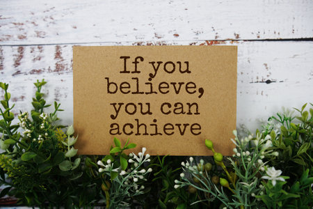 If you believe, You can achieve text message motivational and inspiration quote top view on wooden backgroundの写真素材