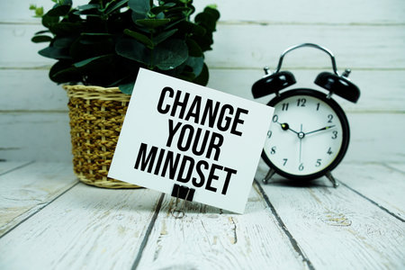Change Your Mindset text on paper card with alarm clock on wooden backgroundの写真素材